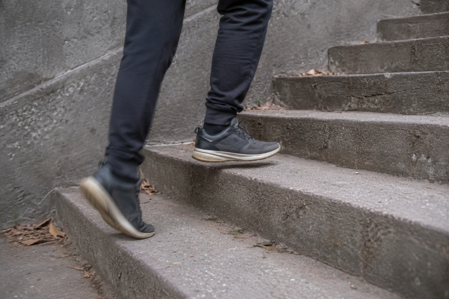 Close-up of legs walking up outdoor steps, showing that everyday movement counts toward exercise motivation