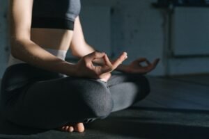 A person practicing calm morning breathing by a window as part of a daily stress relief routine