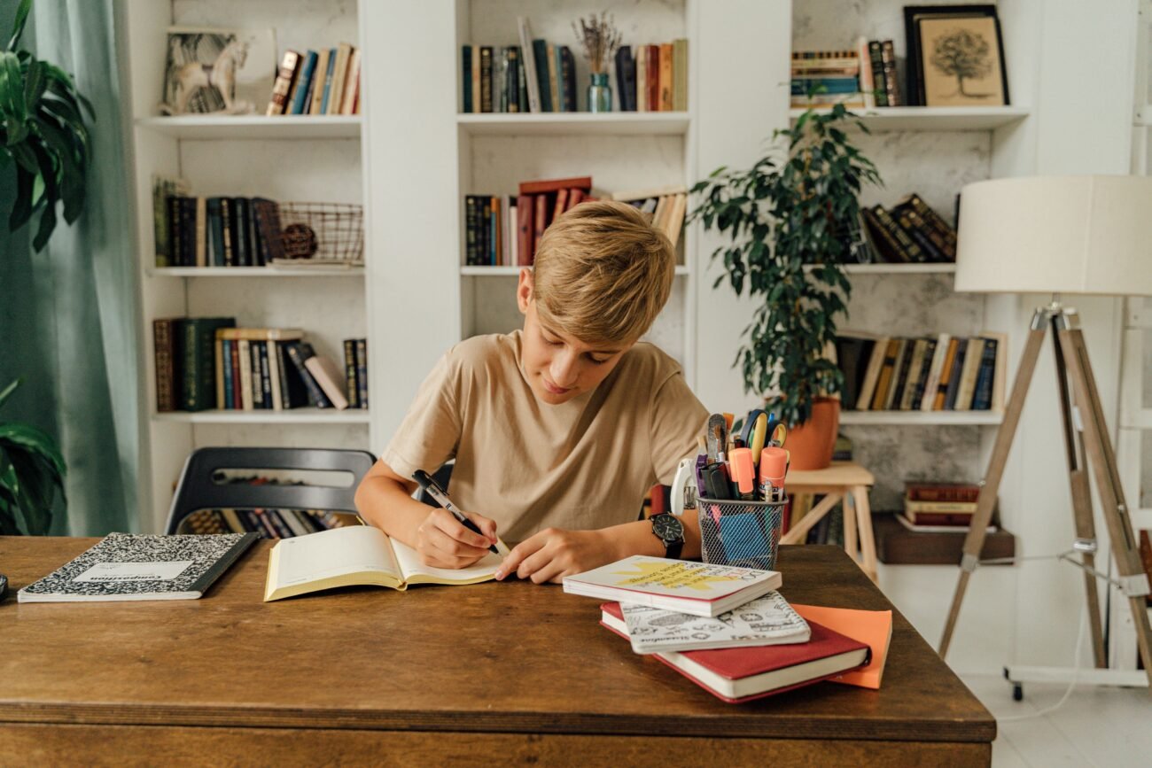A student using a tablet alongside a printed workbook, reflecting a balanced approach to digital learning