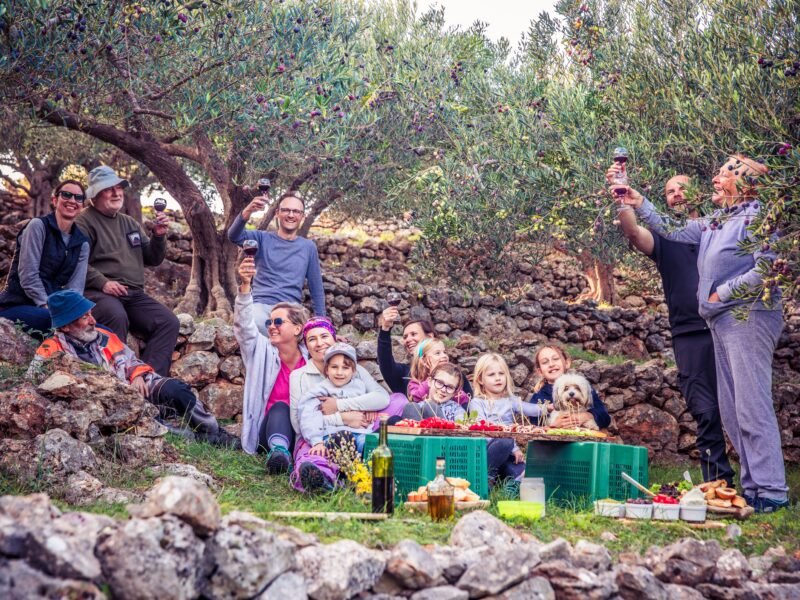 A multigenerational family walking together outdoors, reflecting thoughtful family trip planning