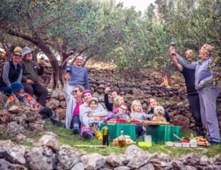 A multigenerational family walking together outdoors, reflecting thoughtful family trip planning