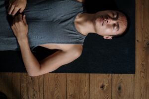 A person practicing diaphragmatic breathing with one hand on their stomach