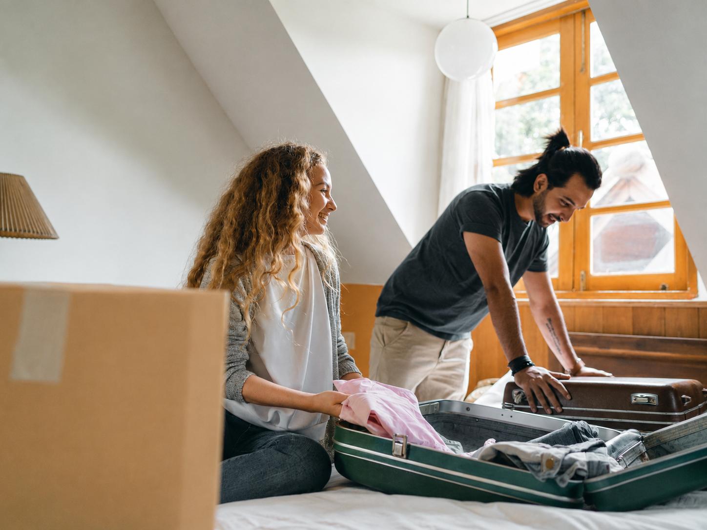 Two people packing a suitcase together, applying travel tips for group and family trips