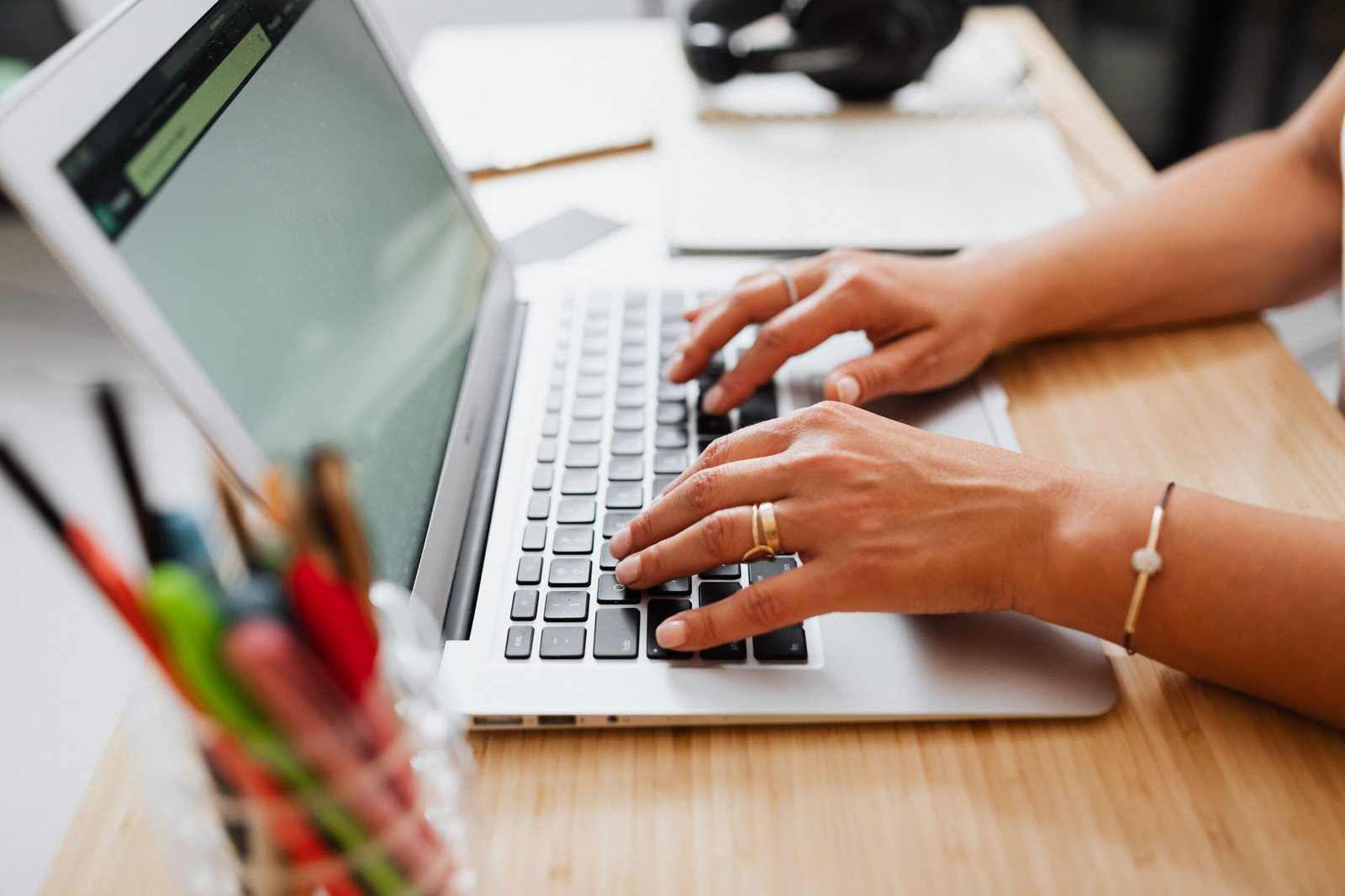 Hands typing on a laptop while considering a career decision related to job hugging