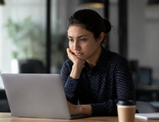 Tired professional resting at their desk, illustrating job hugging and workplace burnout